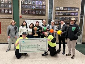 Image of YouthBank grantees with dodgeballs and their grant award check.