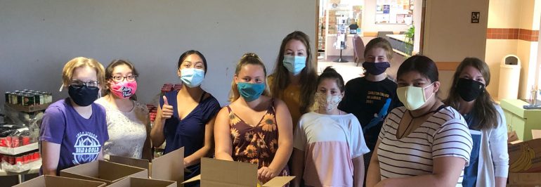 Image of multiple students volunteering in masks